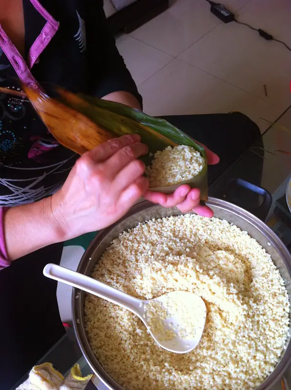Fold the leaves over the sticky rice