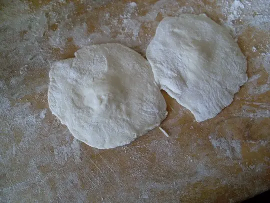 Press the dough into dumpling skins.